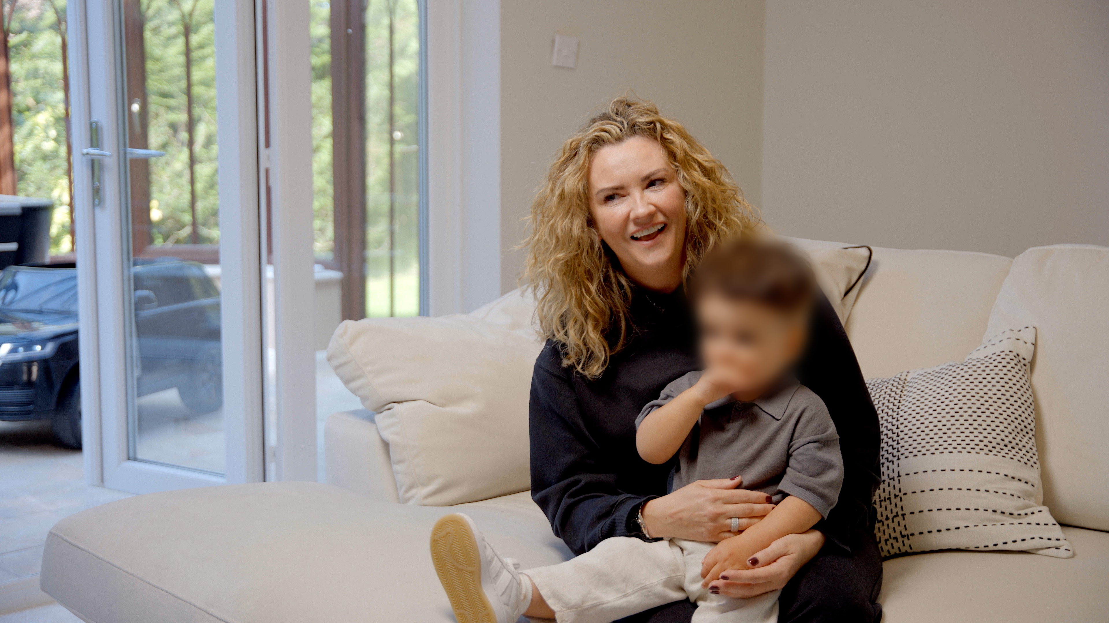 Woman with her young son sat on her lap